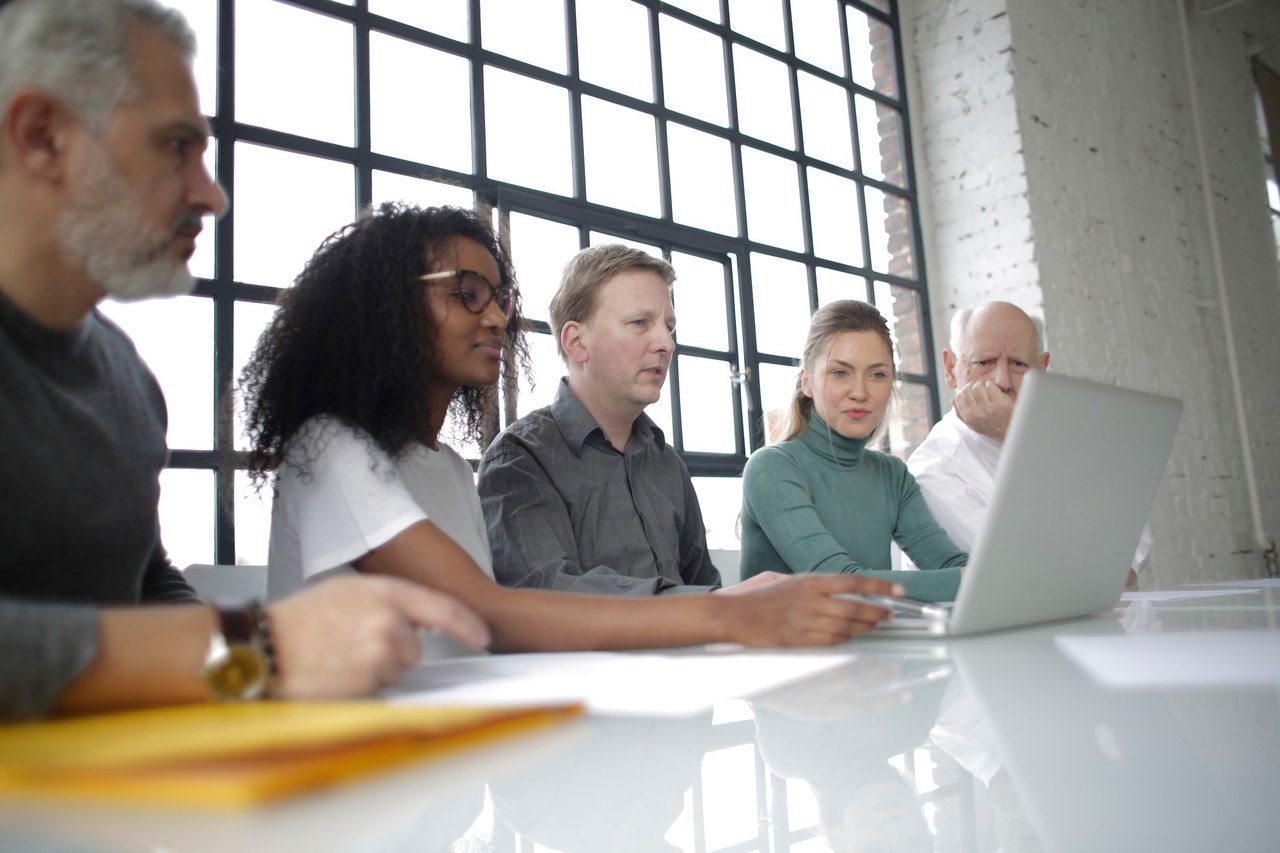 Colleagues reviewing work together in a bright office