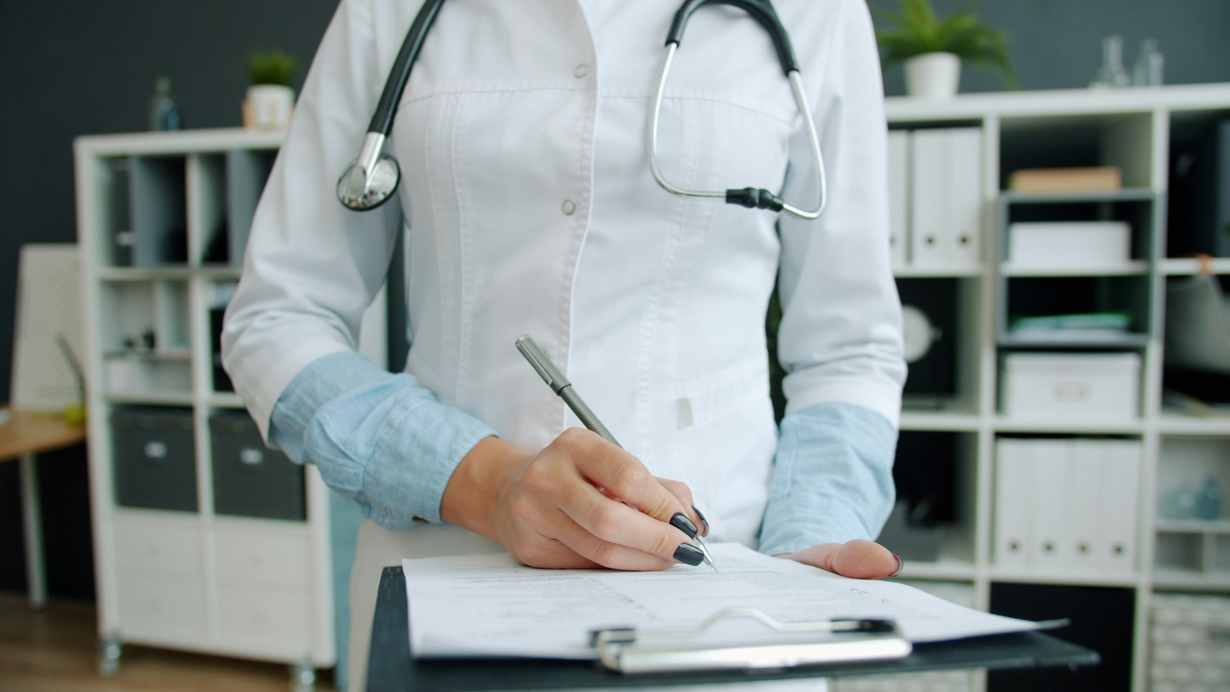 Healthcare professional completing detailed paperwork