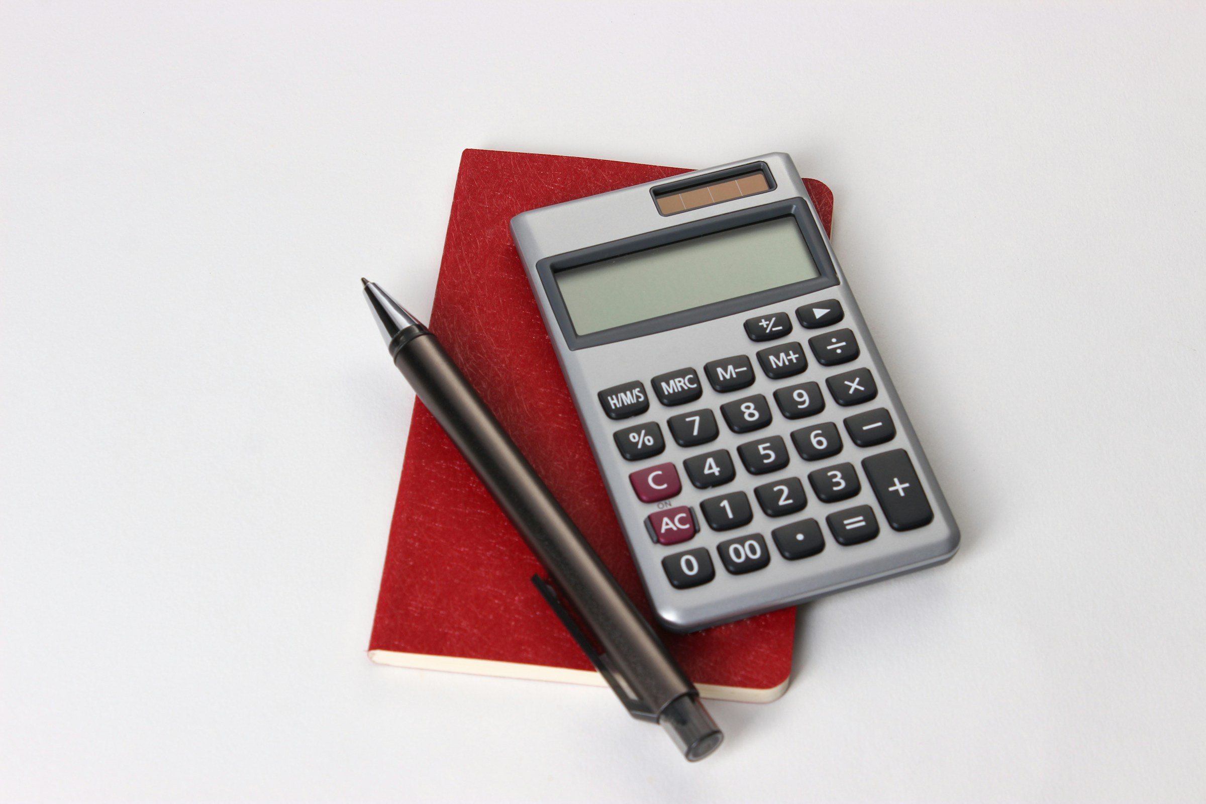 Calculator, pen and records prepared for account review