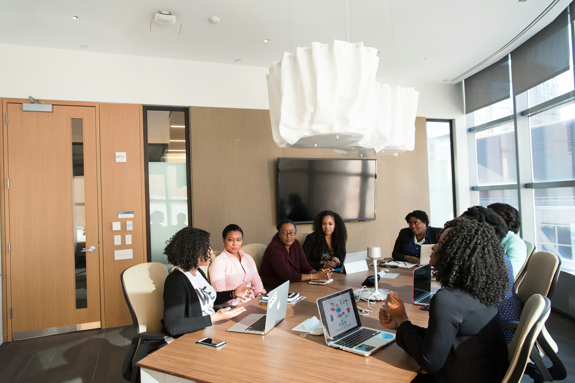 Colleagues coordinating detailed operational work in a modern office